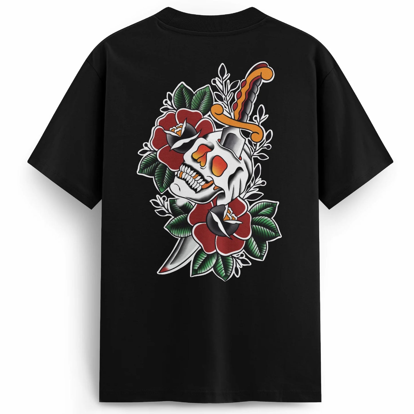 Black premium oversized t-shirt with a bold back print featuring a skull split by a dagger, surrounded by deep red traditional roses and green leaves. Classic tattoo-style design with high contrast and vibrant detail.
