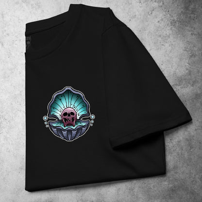 Cursed Pearl Pocket Tee in black, featuring a bold skull within an oyster shell design. Tattoo-inspired graphic with gritty detailing, presented on a folded heavyweight t-shirt.