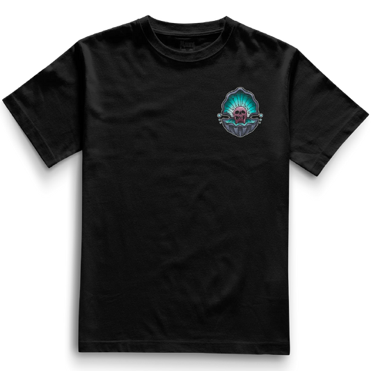 Cursed Pearl Pocket Tee in black, displaying a front-facing design of a skull within an oyster shell. Bold, traditional tattoo style on a relaxed fit heavyweight t-shirt.
