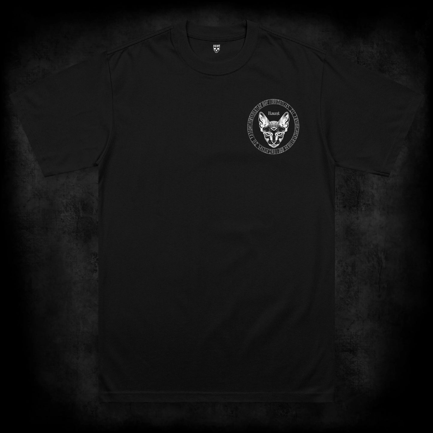 Front view of the Eventide t-shirt featuring a small left chest print of a three-eyed sphynx cat surrounded by a circular blackletter rune design on a black heavyweight garment.