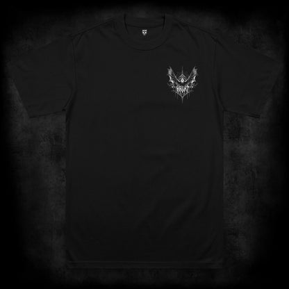 Front view of the Nocturne occult t-shirt featuring a small left chest print of a bat with spread wings above gothic Haunt lettering and thorn details on a black heavyweight garment.