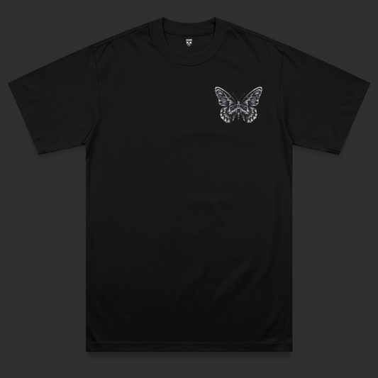 Front view of the Omen heavyweight t-shirt featuring a black and grey moth chest print with skull-inspired detailing on a black heavyweight garment.
