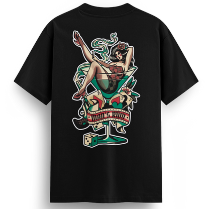 Back of the Man’s Ruin t-shirt showing a vintage-style tattoo design of a lady lounging in a martini glass with a gun, cigarette, and dice, in full-color traditional ink style.
