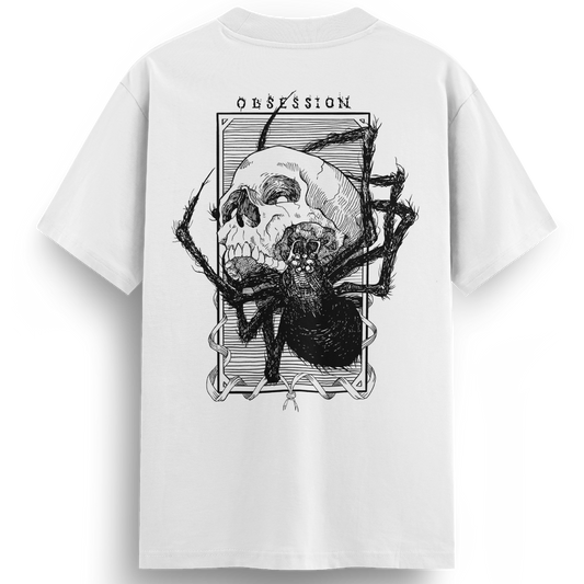 Back of the Obsession white t-shirt showcasing a bold black linework tattoo-style illustration of a skull being devoured by a spider, framed with the word “OBSESSION” at the top.