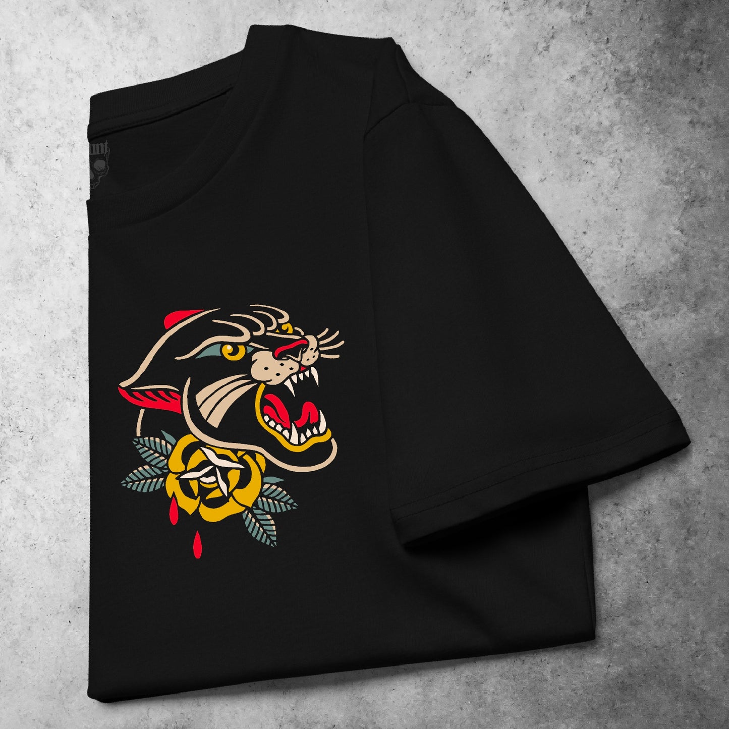 Folded front view of the Pocket Panther t-shirt from the Haunt Pocket Collection, featuring a snarling panther head in traditional tattoo style printed on the left chest
