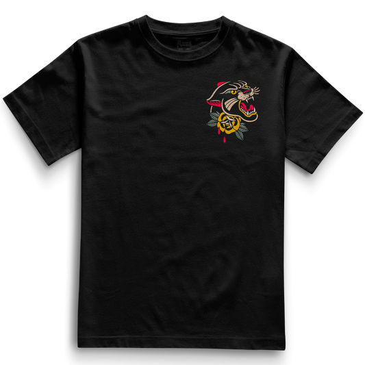 Front of the black Pocket Panther t-shirt from Haunt’s Pocket Collection featuring a bold traditional tattoo-style panther head above a classic rose, in vibrant red, yellow, green, and beige tones.