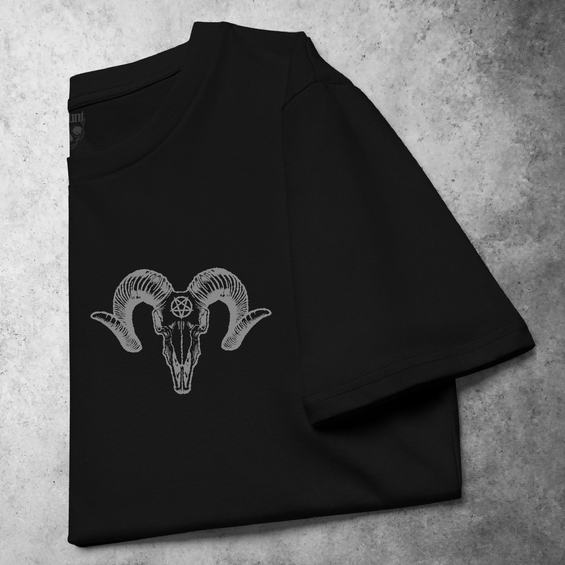 Folded front view of the Pocket Ramskull t-shirt from the Haunt Pocket Collection, featuring a white ram skull design printed above the left chest