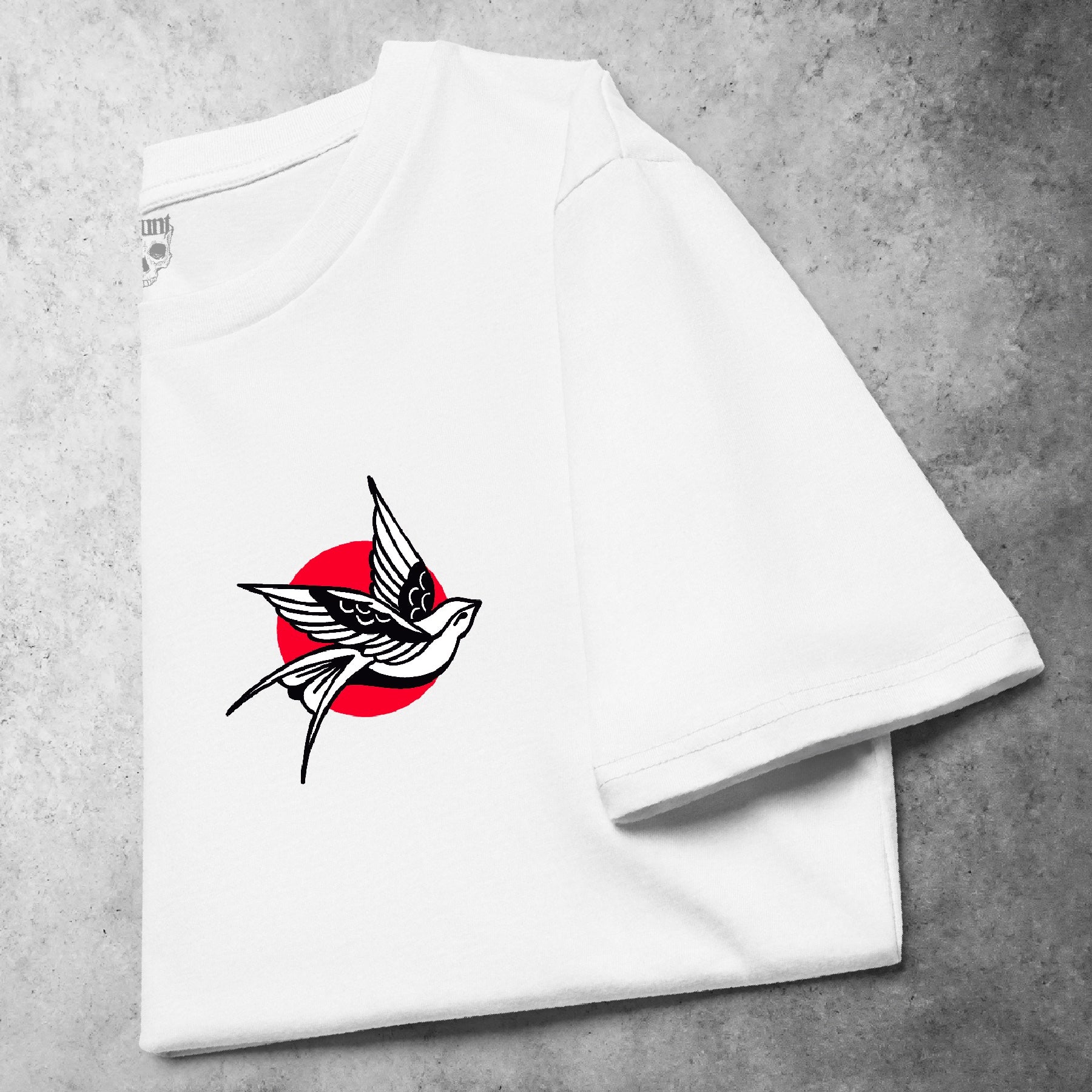Folded front view of the Pocket Swallow t-shirt from the Haunt Pocket Collection, featuring a white traditional-style swallow in flight on the left chest