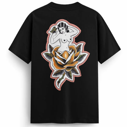 Back of the Softcore Bloom tee showing a pastel traditional rose with a topless woman blooming from it, holding a butterfly. Feminine, vintage-inspired tattoo design with soft pinks and bold linework.
