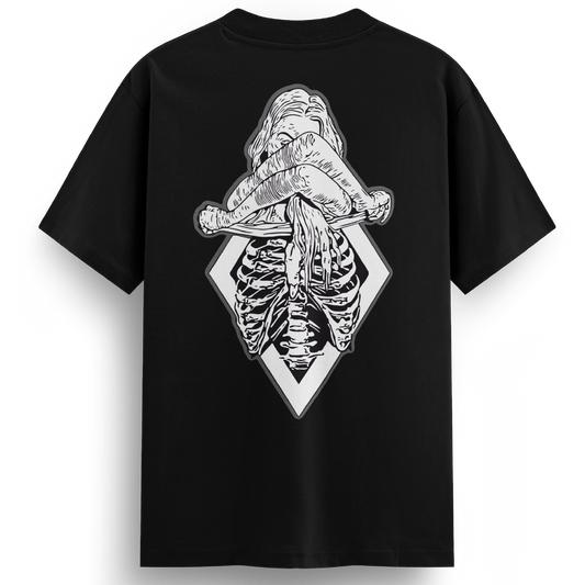 Back of the XXX-Ray black t-shirt displaying a black and white tattoo-style illustration of a topless woman revealing her ribcage in x-ray detail, set against a diamond-shaped frame.
